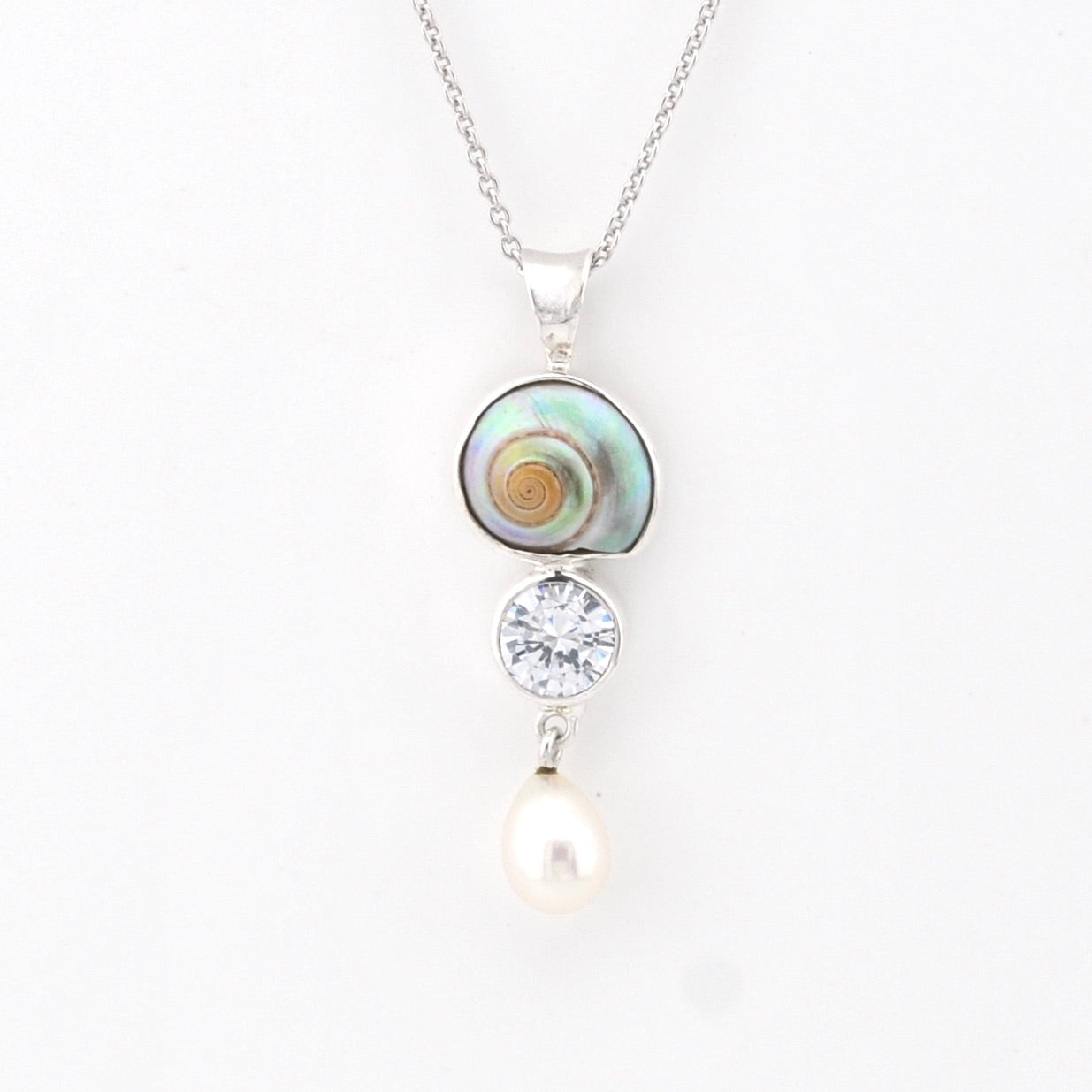 Necklace with a shell pendant, cz, and pearl on a white background