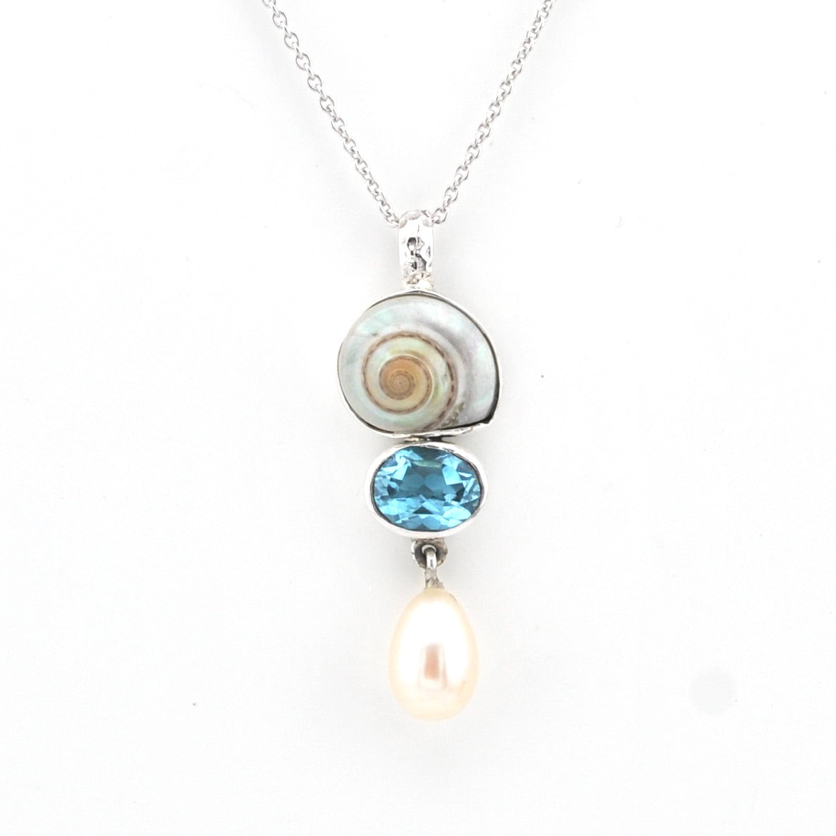 Necklace with a pendant featuring a blue gemstone and pearl on a white background