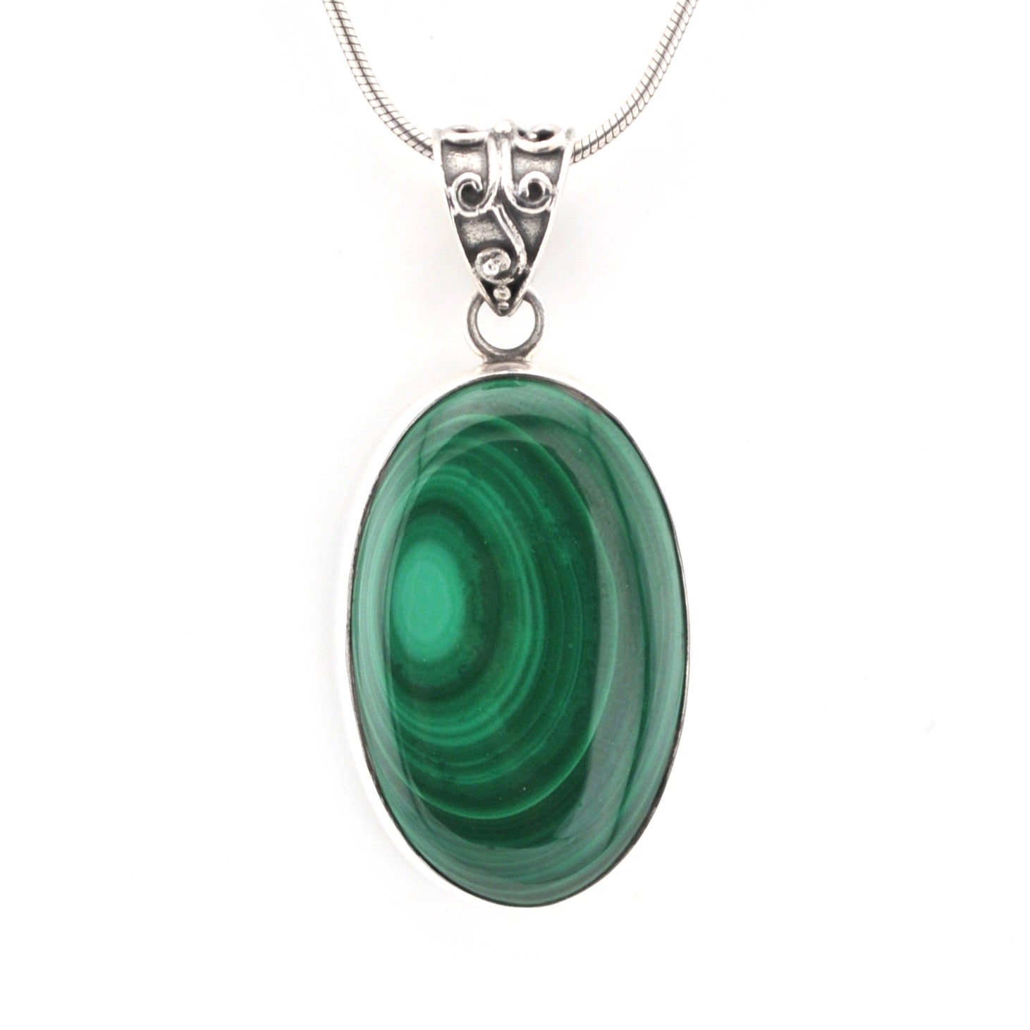 Green malachite pendant on a silver chain against a white background