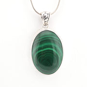 Green stone pendant on a white background