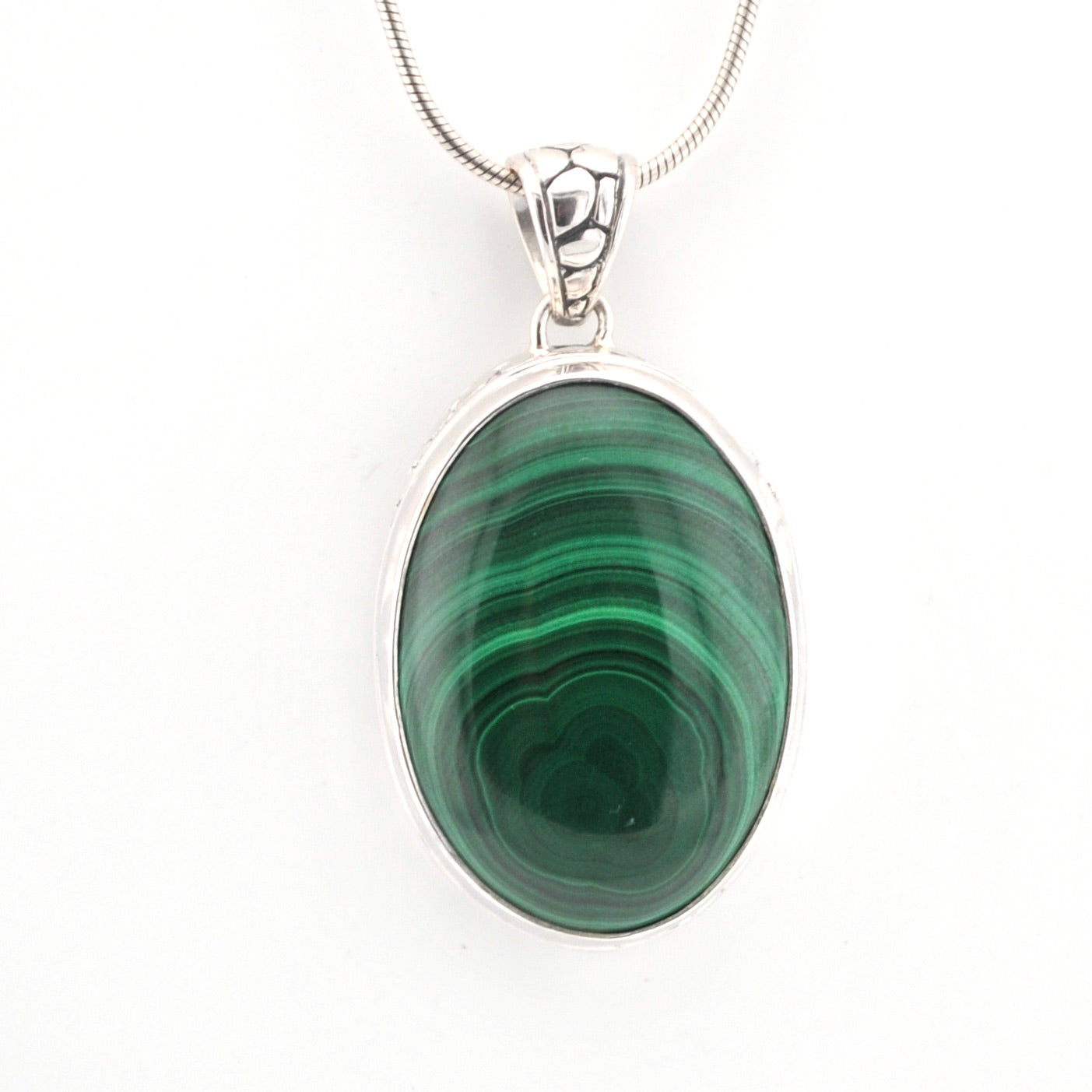 Green stone pendant on a white background