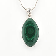 Green malachite pendant on a silver chain against a white background