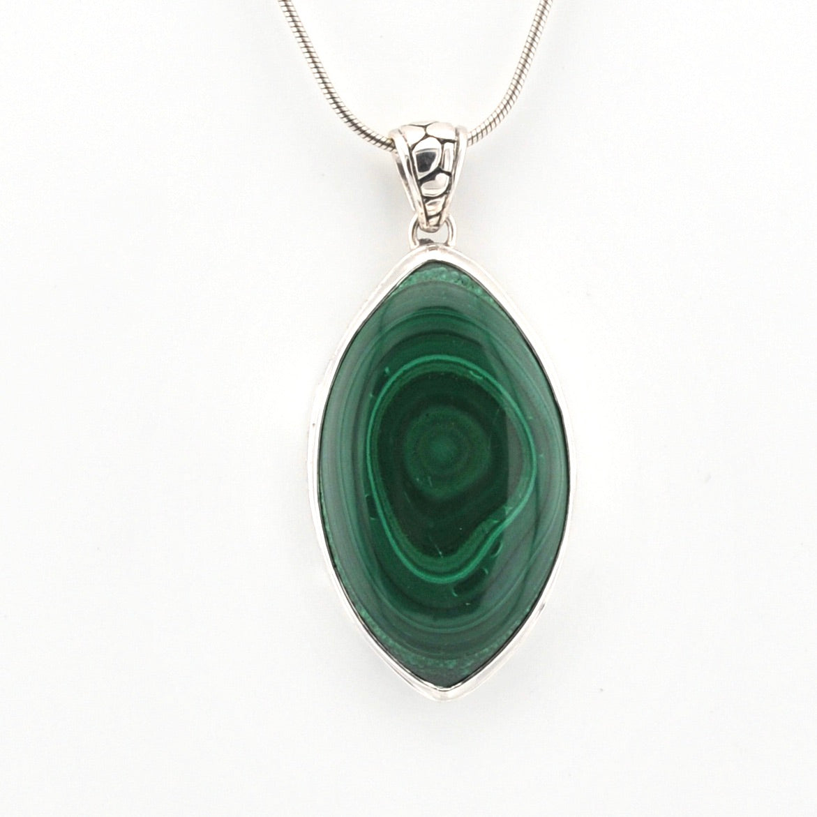 Green malachite pendant on a silver chain against a white background