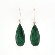 Teardrop-shaped green earrings on a white background