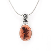 Necklace with an oval pendant featuring a brown and black pattern on a white background