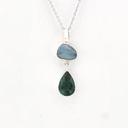 Necklace with two teardrop-shaped gemstones on a white background