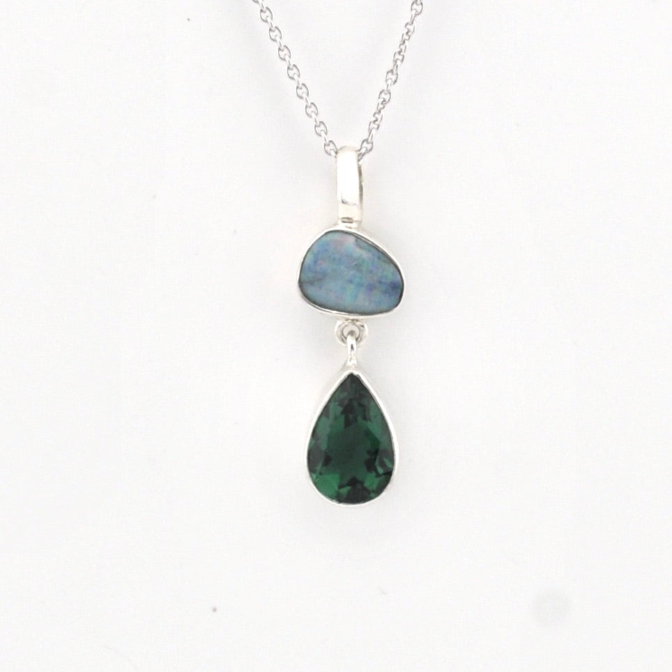 Necklace with two teardrop-shaped gemstones on a white background