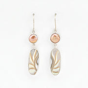 Pair of earrings with pink and beige stones on a white background