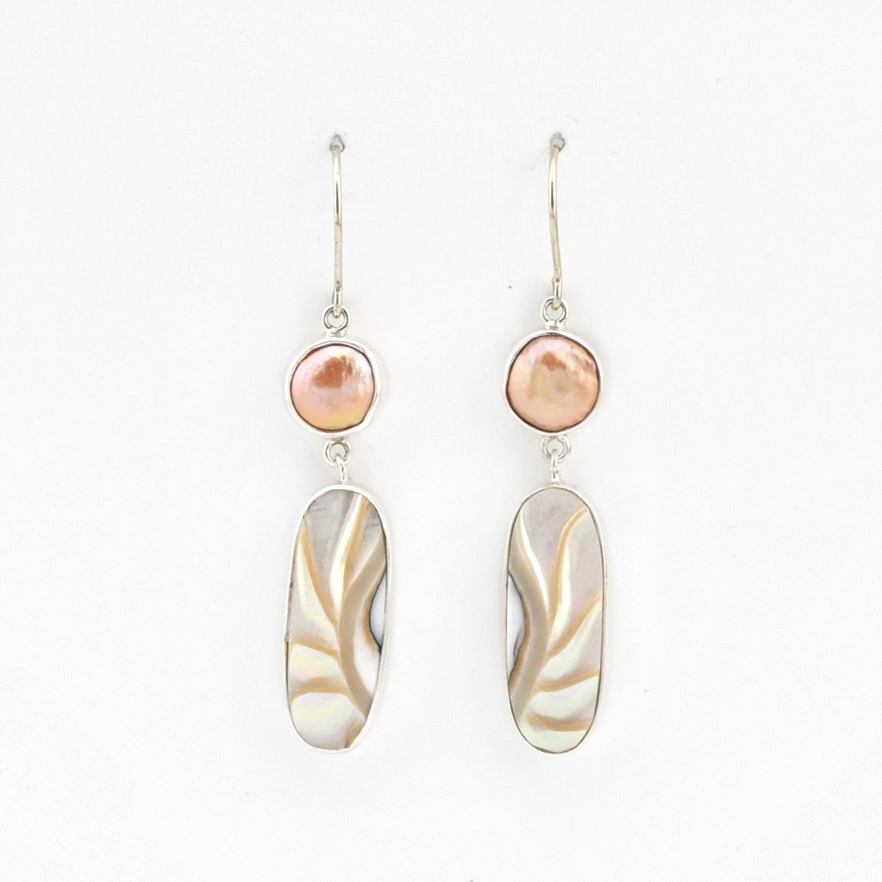 Pair of earrings with pink and beige stones on a white background