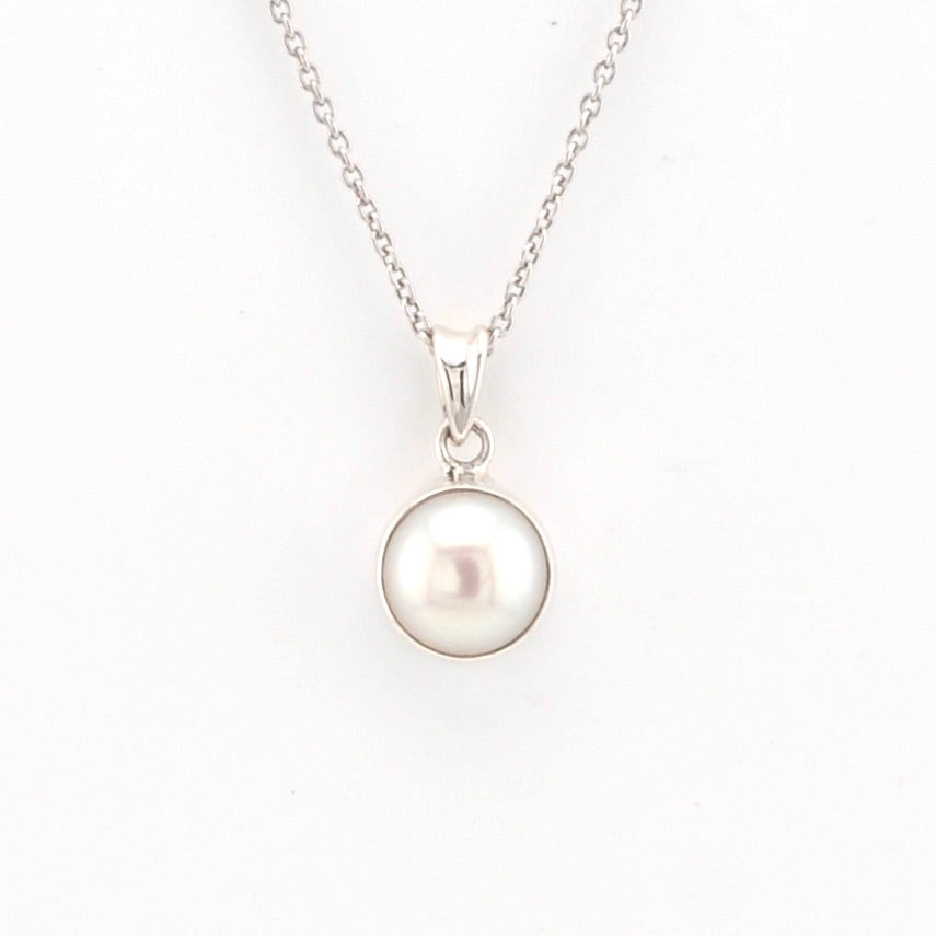 Pearl necklace with silver chain on a white background