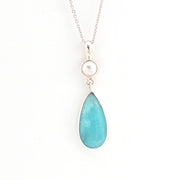 Necklace with a teardrop-shaped turquoise pendant on a white background