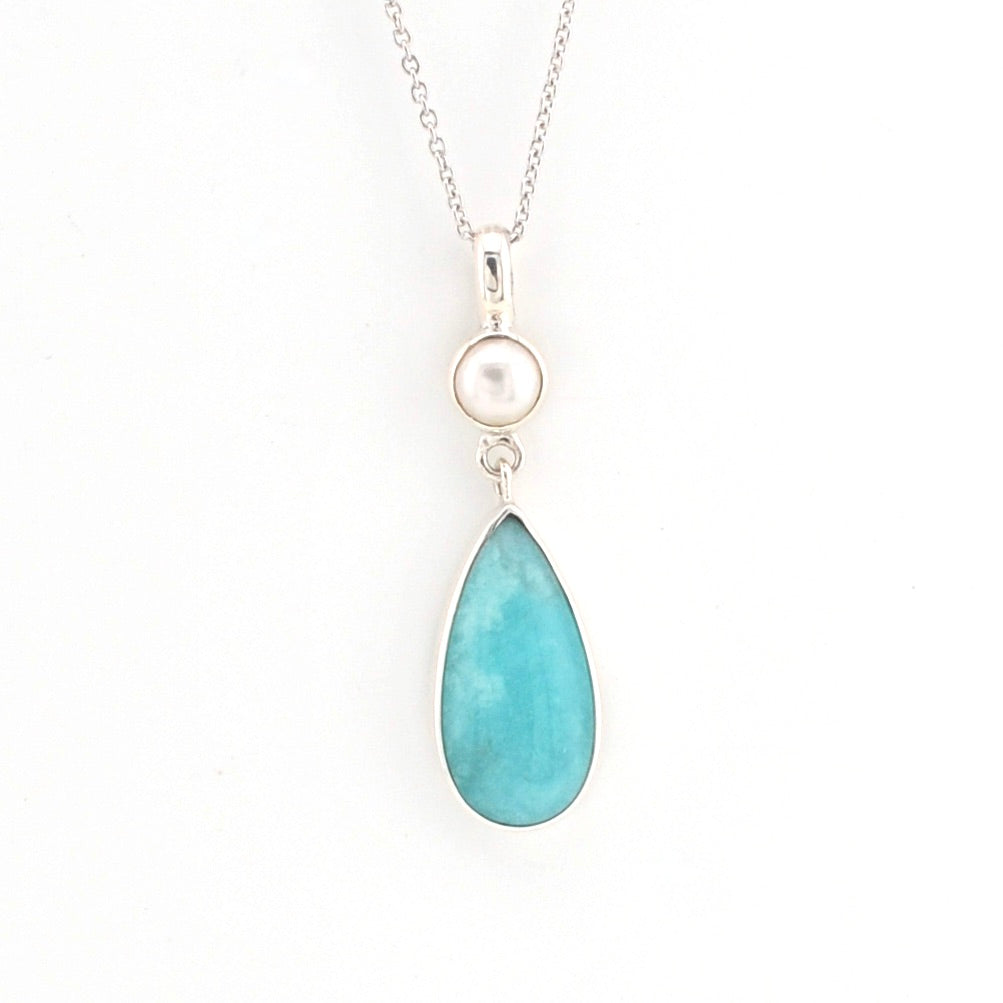 Necklace with a teardrop-shaped turquoise pendant on a white background