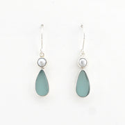 Teardrop-shaped earrings with light blue stones and pearl-like tops on a white background