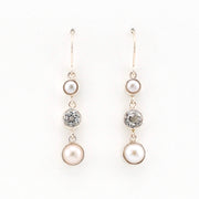 Pair of pearl and topaz drop earrings on a white background
