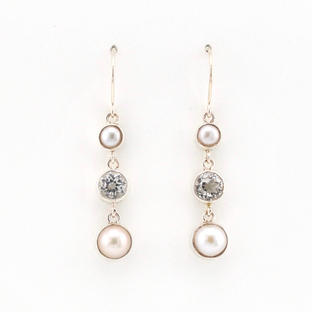 Pair of pearl and topaz drop earrings on a white background