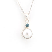 Necklace with a pearl pendant and blue gemstone on a white background