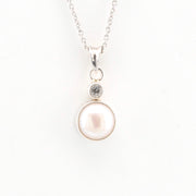 Pearl necklace with a silver chain on a white background