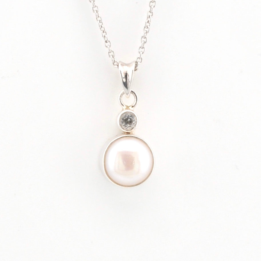 Pearl necklace with a silver chain on a white background