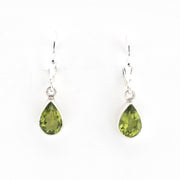 Pair of green teardrop earrings on a white background
