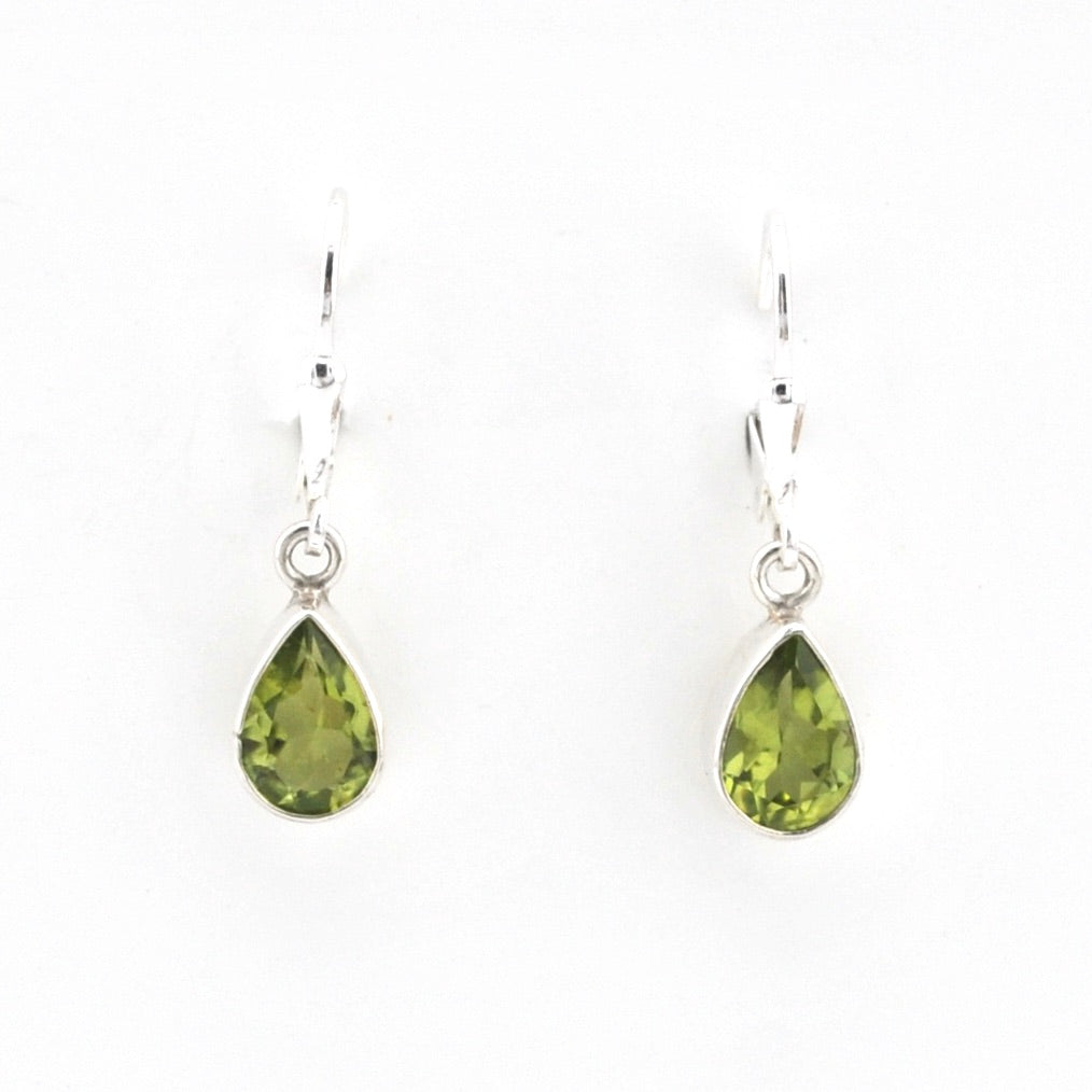 Pair of green teardrop earrings on a white background