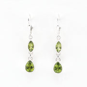 Pair of green teardrop earrings on a white background