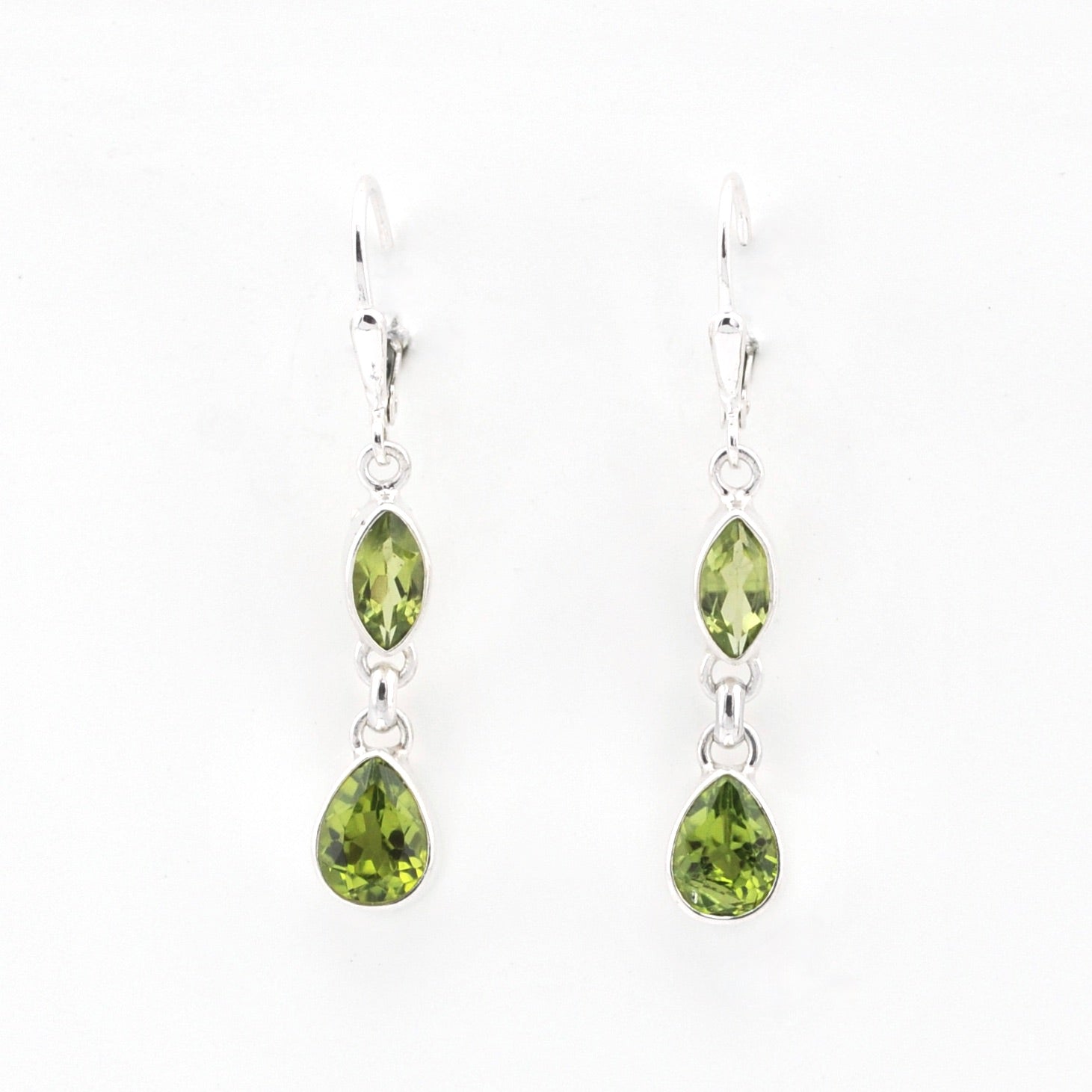 Pair of green teardrop earrings on a white background