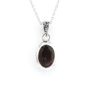 A silver pendant necklace featuring an oval dark brown gemstone in a textured silver bezel setting, suspended from a delicate silver chain against a plain white background.