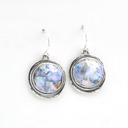 Pair of earrings with circular designs on a white background