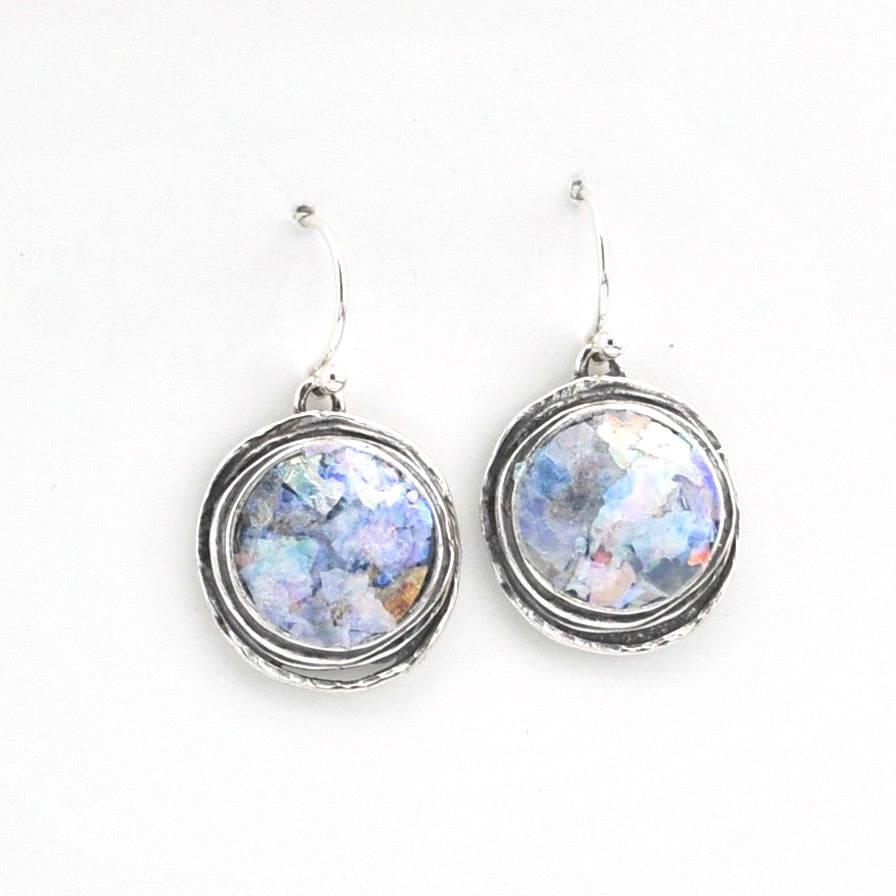 Pair of earrings with circular designs on a white background