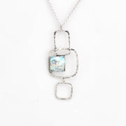 Silver necklace with a pendant featuring a Roman glass on a white background