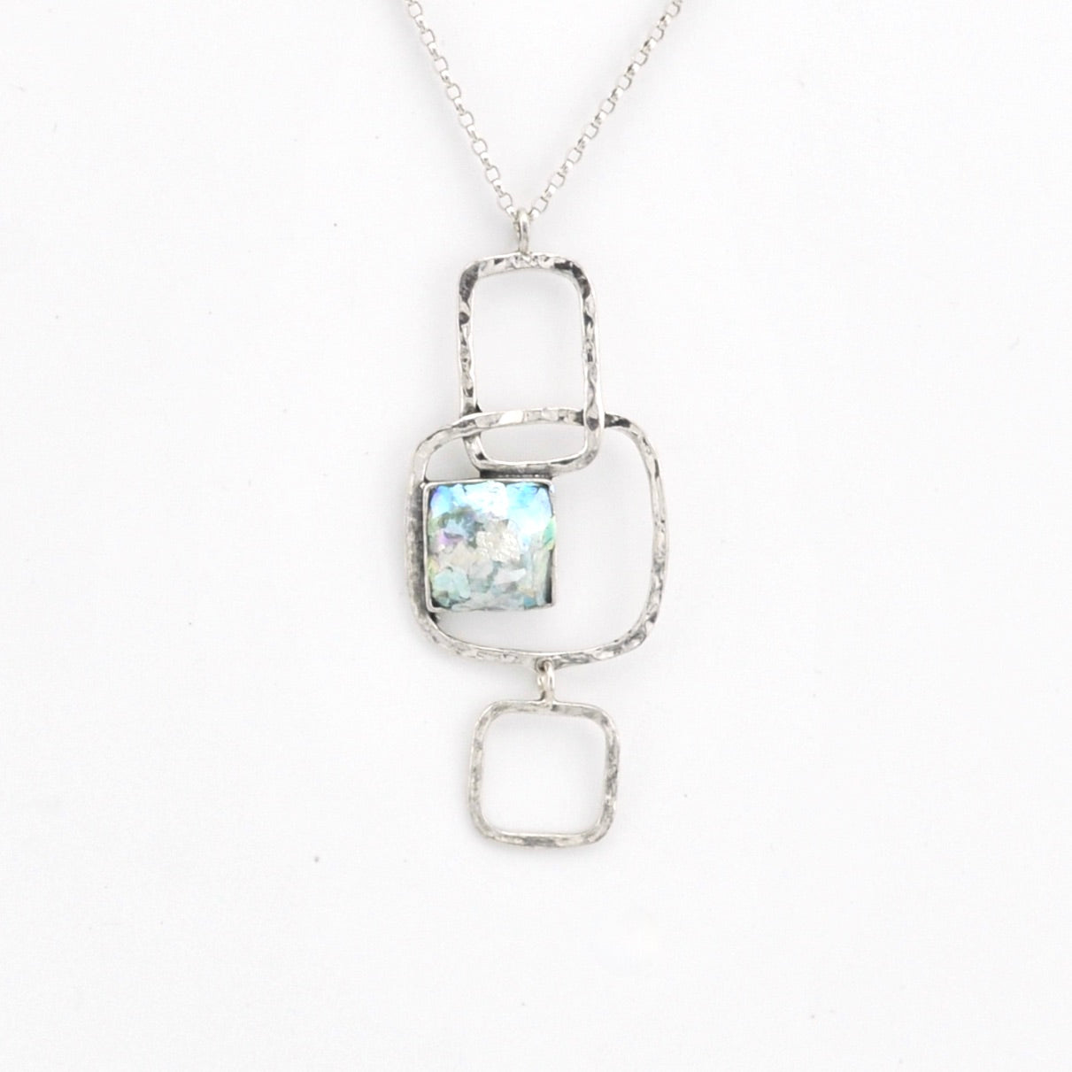 Silver necklace with a pendant featuring a Roman glass on a white background