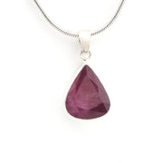 Teardrop-shaped purple gemstone pendant on a silver chain against a white background