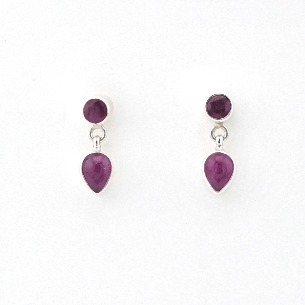Pair of earrings with purple teardrop-shaped gemstones on a white background