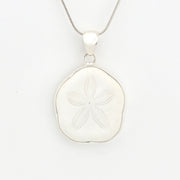 Silver sand dollar pendant on a white background