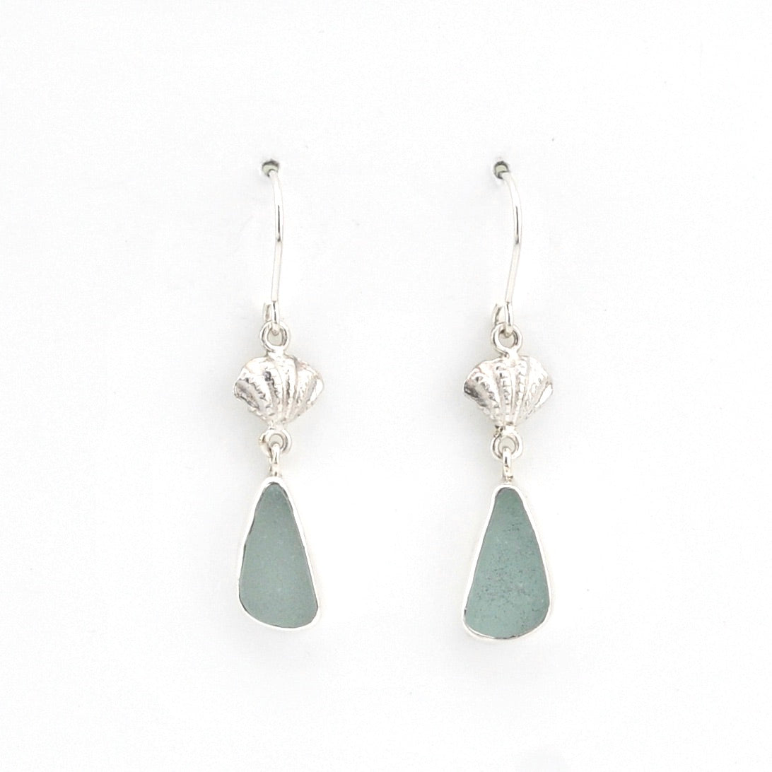 Pair of silver earrings with green teardrop-shaped stones on a white background