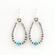 Pair of beaded earrings with turquoise accents on a white background