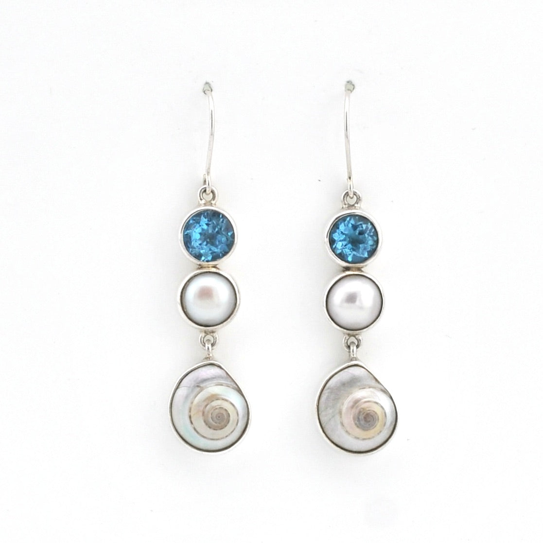 Pair of earrings with blue gemstones and pearl-like elements on a white background
