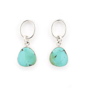 Turquoise earrings with silver hooks on a white background