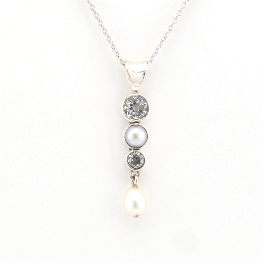 Necklace with three pearls and two gemstones on a white background
