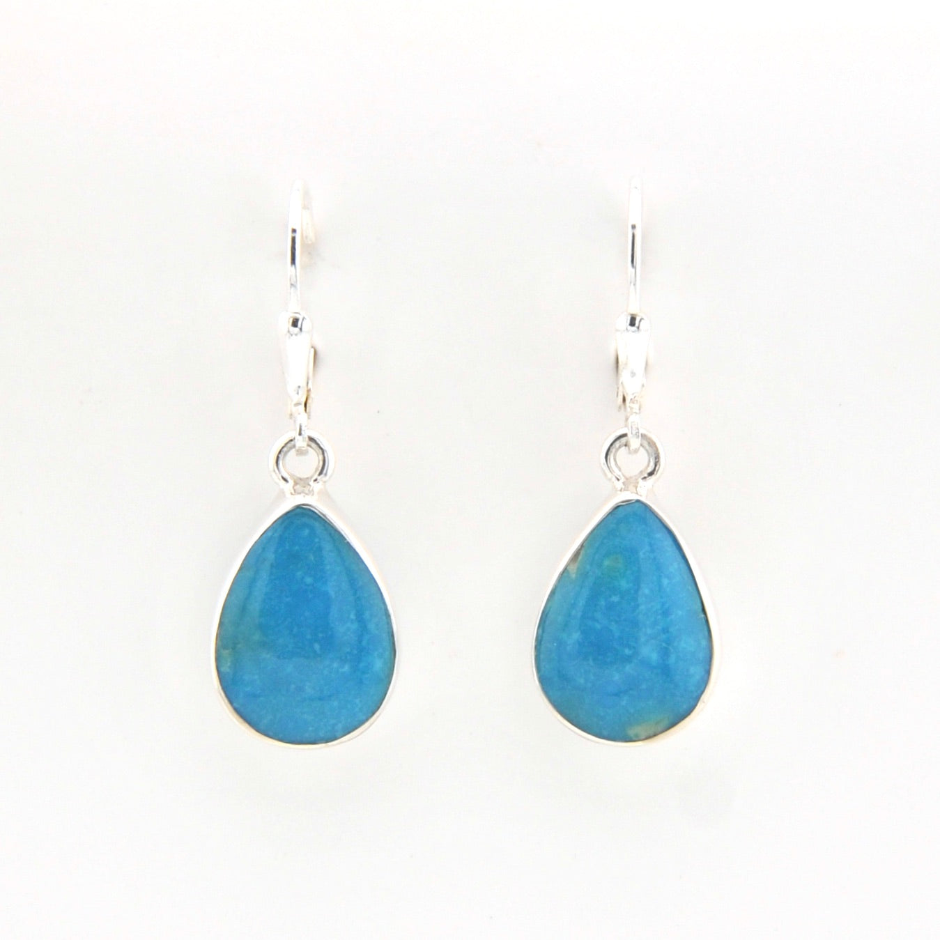 Teardrop-shaped blue earrings on a white background
