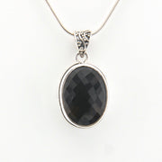 Brown pendant on a silver chain against a white background
