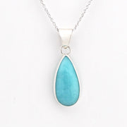 A silver teardrop pendant necklace featuring a smooth, polished light blue stone, suspended from a delicate silver chain against a plain white background.
