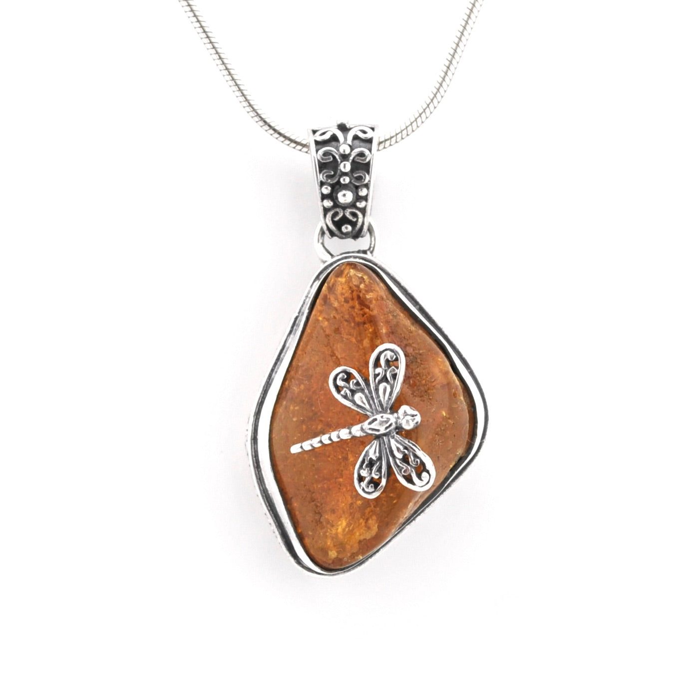 A silver dragonfly pendant necklace featuring a brown textured stone bezel on a white background.