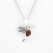 A sterling silver hummingbird pendant necklace with a polished amber gemstone in its body, suspended from a delicate silver chain against a plain white background.