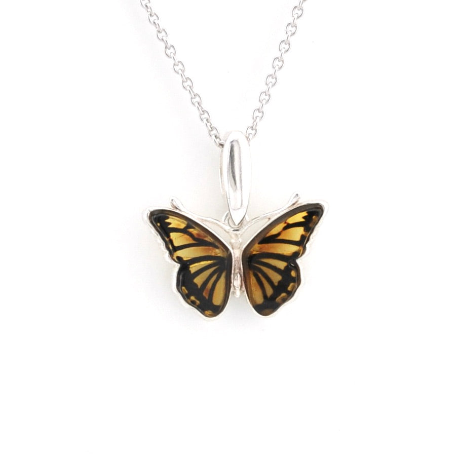 A silver butterfly pendant necklace with yellow and black patterned wings, suspended from a delicate silver chain against a plain white background.