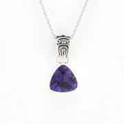 A silver pendant necklace featuring a triangular purple gemstone in a bezel setting, suspended from a delicate silver chain against a plain white background.