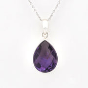 A silver teardrop pendant necklace featuring a faceted purple amethyst gemstone, suspended from a delicate silver chain against a plain white background.