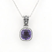 A silver pendant necklace featuring a square-cut purple gemstone in a silver bezel setting, suspended from a delicate silver chain against a plain white background.