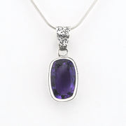 A silver pendant necklace featuring a bezel-set oval purple gemstone on a delicate silver chain, shown against a plain white background.