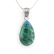 A teardrop-shaped pendant necklace featuring a green azurite gemstone with blue flashes, set in a silver bezel with a silver bail, suspended from a silver chain against a white background.